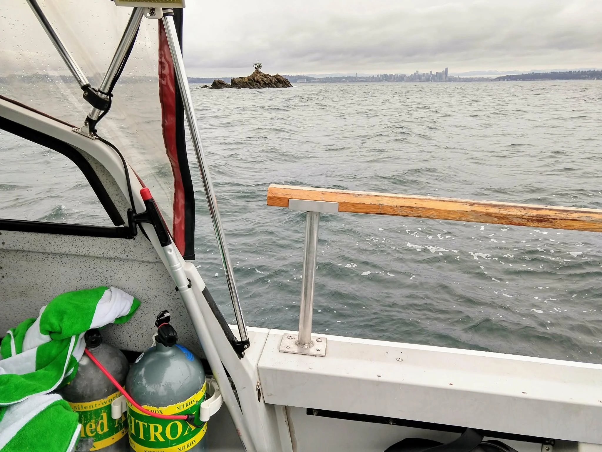 Blakely Rock dive sites Shangri La and China Wall near Bainbridge Island. You can see the Seattle skyline in the distance. Photo by Scuba Jess.