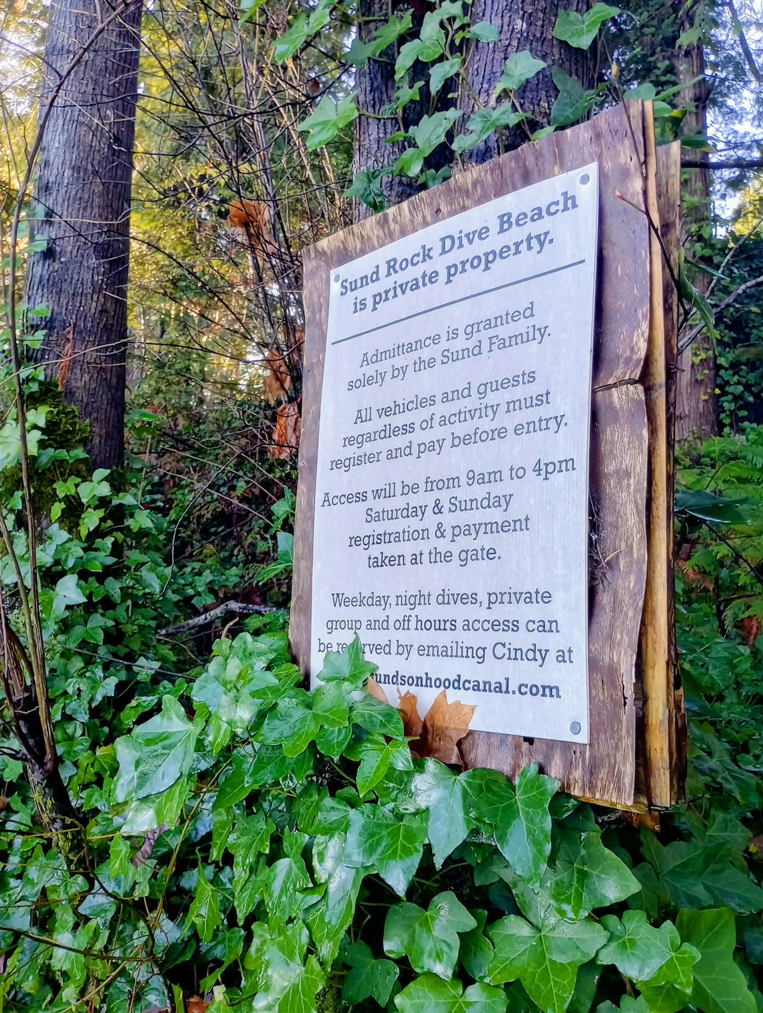 Registration sign at the Sund Rock property entrance. Reservations are required — see the briefing and resource links for current access and booking info.